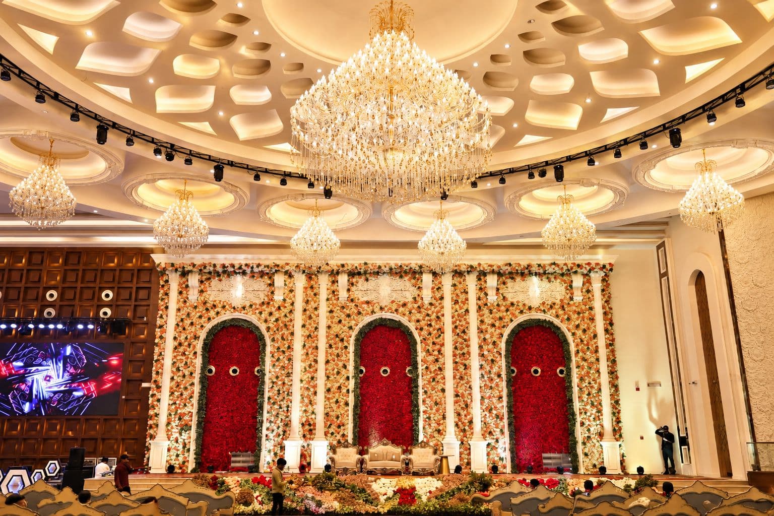 Wedding Crown banquet hall in Sector 73, Noida, decorated with a floral mandap and crystal chandeliers